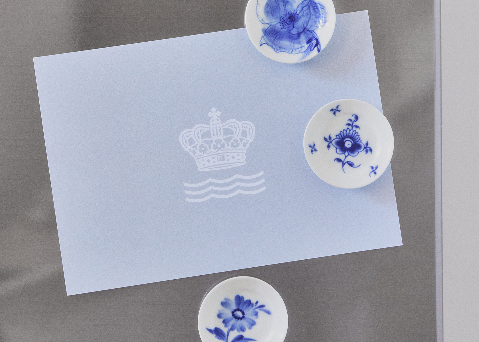 A miniature Royal Copenhagen plate handpainted and used as a fridge magnet
